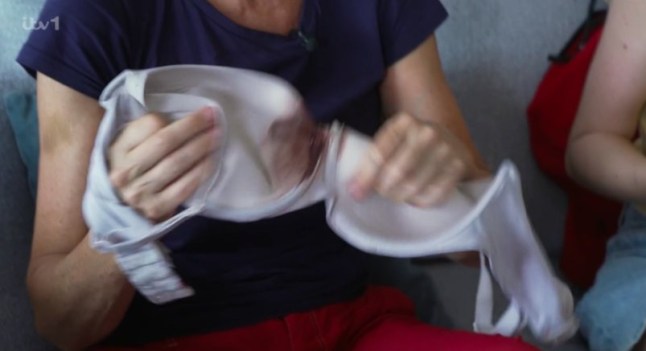 Jane Moore holds light coloured bra with blood on it
