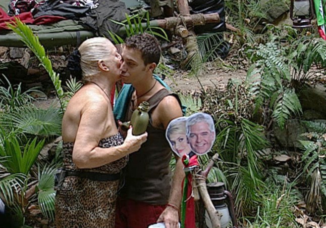 Editorial use only Mandatory Credit: Photo by ITV/REX/Shutterstock (1052851eo) Kim Woodburn and Gino D'Acampo kiss 'I'm A Celebrity Get Me Out Of Here!' TV Programme, Australia - 01 Dec 2009 Things got a little touchy feely in the 'I'm A Celeb' jungle today after Kim admitted she was missing George and needed a man. The end result was that both Gino and Stuart are flirting with her, kissing her hand and complimenting her. Gino commented: ?She?s a voluptuous woman and she will always be randy. I know she likes the attention and so do I so we play with each other.? Meanwhile, following on from all the female flesh flashing that has been carrying on in the jungle Gino decided to get in on the action. The celeb chef stripped off and lathered up to enjoy a naked shower - cheekily flashing his bottom to the cameras.