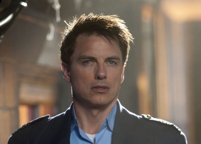 John Barrowman as Captain Jack Harkness wearing a blue shirt in Doctor Who spin-off Torchwood