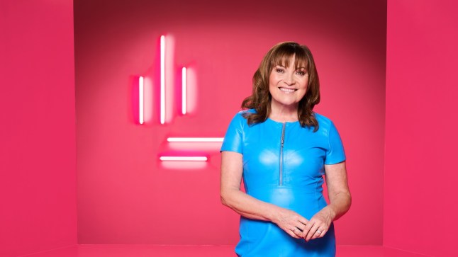 Lorraine Kelly in blue PVC dress against red backdrop