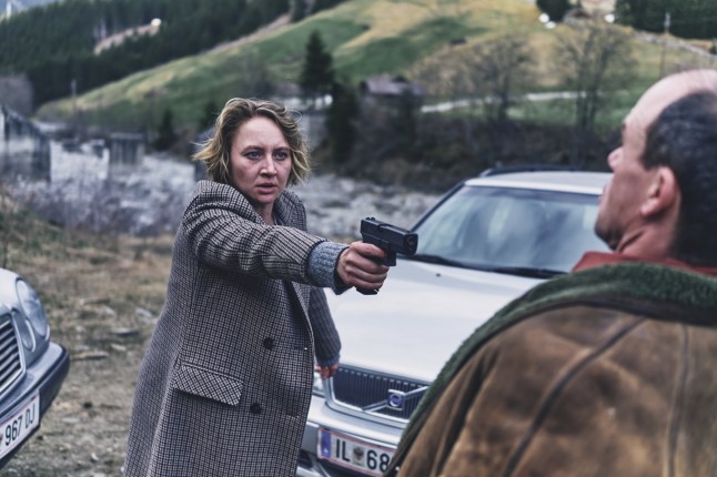 A still from Woman of the Dead of a woman pointing a gun at an anonymous man