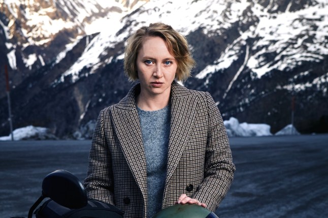 A still from Woman of the Dead of main character stood in front of snowy mountains